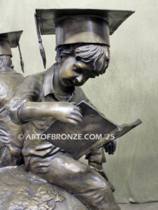 Global Scholars bronze statue of boy and girl sitting on globe reading book