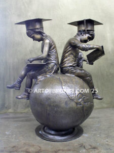 Global Scholars bronze statue of boy and girl sitting on globe reading book