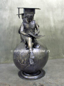 Global Scholars bronze statue of boy and girl sitting on globe reading book