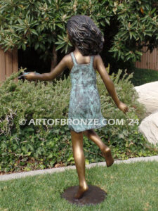 Joyful Discovery bronze sculpture of young girl running with sea turtle