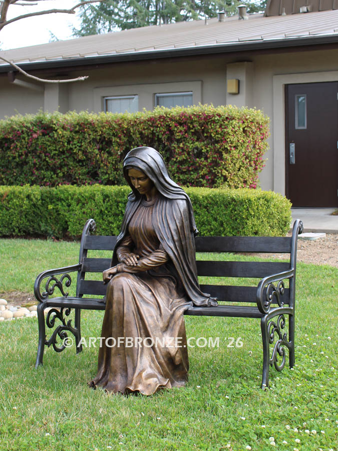 Holy Spirit Catholic Church bronze sculpture of Blessed Virgin Mary sitting on bench