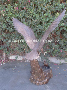 Dinner for Two falcon bronze statue of a life-size flying falcon into nest with baby falcon