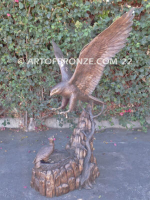 Dinner for Two falcon bronze statue of a life-size flying falcon into nest with baby falcon