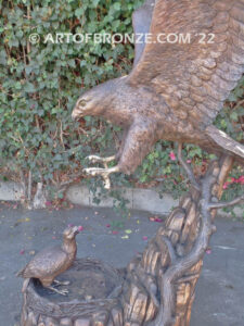 Dinner for Two falcon bronze statue of a life-size flying falcon into nest with baby falcon