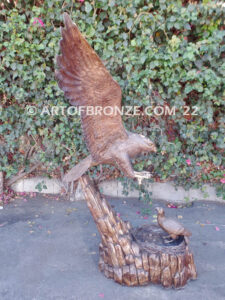 Dinner for Two falcon bronze statue of a life-size flying falcon into nest with baby falcon