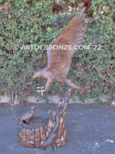 Dinner for Two falcon bronze statue of a life-size flying falcon into nest with baby falcon