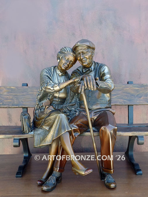 Valentine senior couple sitting on bench bronze sculpture by George Lundeen